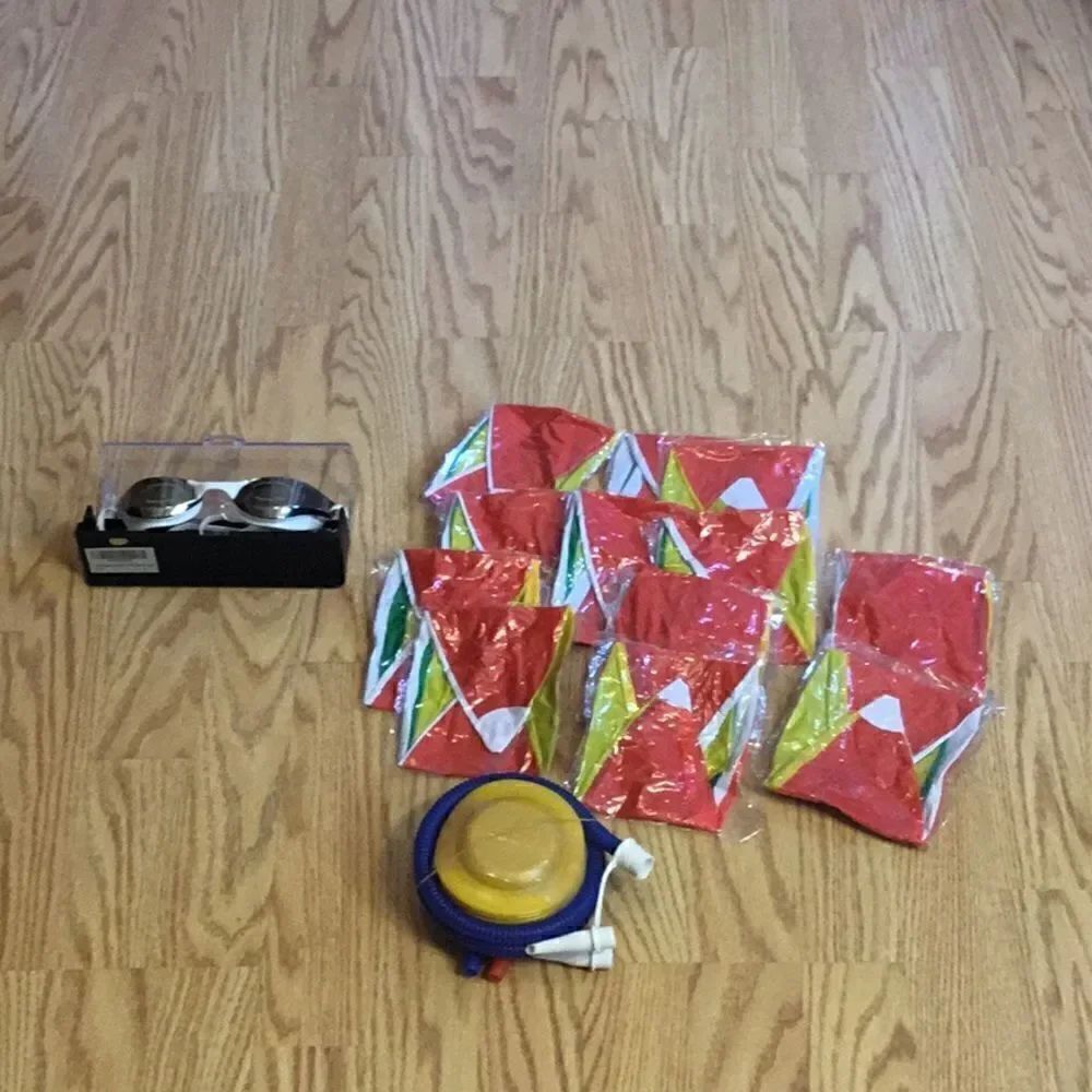 New stock. Swim lot 1 pair swim goggles, 14 beach balls with 1 foot inflatabler
